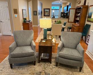 Two matching reading chairs and an end table that coordinate to the rug and the loveseat. Two matching table lamps and a floor lamp.