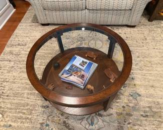 36-inch Glass-top display coffee table on small rolling casters.