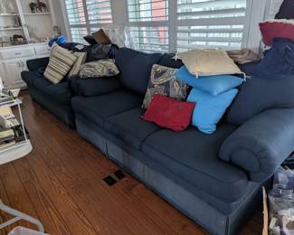 2 blue couches with many pollows