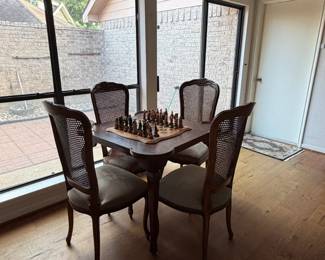 Game table with cane back chairs