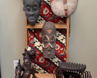 Assortment of masks and carved sculptures from around the world.