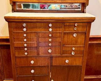 Antique dental cabinet with milk glass top and drawer inserts