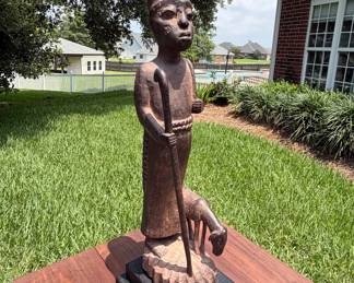 Hand-carved Ethiopian shepherd figure on stand.