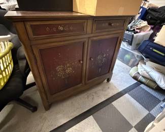 Stein World Chamberlain cabinet features a burgundy finish with a hand-painted floral design on its doors and drawers