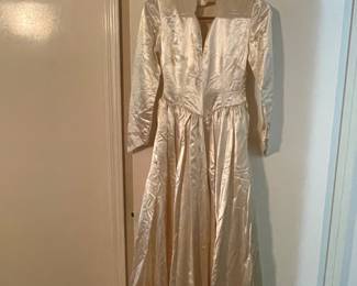 Ivory liquid satin wedding gown from the 1940s features long sleeves and a V-neckline