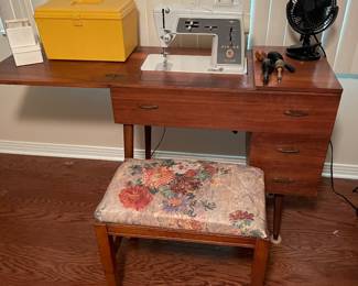 Modern singer sewing machine with many attachments included w/cabinet