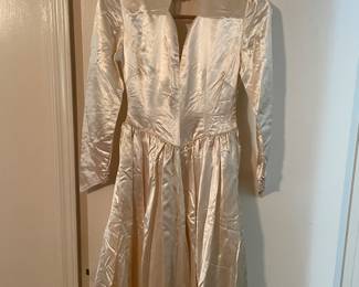 Ivory liquid satin wedding gown from the 1940s features long sleeves and a V-neckline