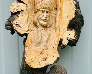 Hand carved relief sculpture of Native American face, bark carving 