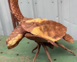 Hand carved wooden sea turtle sculpture mounted on natural branch/driftwood
