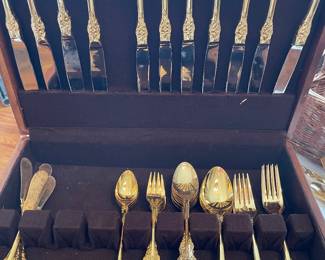 Gold tone flatware and serving pieces