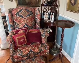 Upholstered antique wing chair with coordinated small metal foot stool