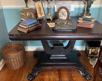 Beautiful antique American empire mahogany table with large paw feet.