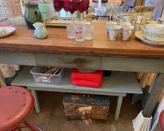 Smaller painted table tucked under larger table