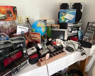 Misc electronics incl stereo system, massager, clocks, light-up glove, digital cameras and photo frames