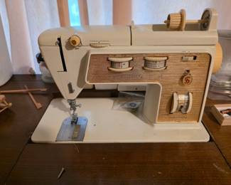 Singer sewing machine in table.