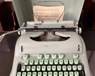 Hermes 3000 typewriter with sea foam green keys. Manual and brushes are present