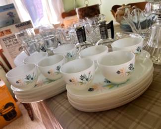 vintage Federal Glass Atomic Flower luncheon snack set, featuring white milk glass plates and cups with a turquoise, pink, and black floral pattern.