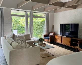 in the cottage: sleeper sectional and king size bed, media cabinet, rug, TV, coffee table