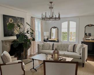 fully furnished living room: julie neill chandelier, art by john bukaty, rug, furniture, mirrors