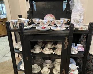Antique display cabinet; cups/saucers