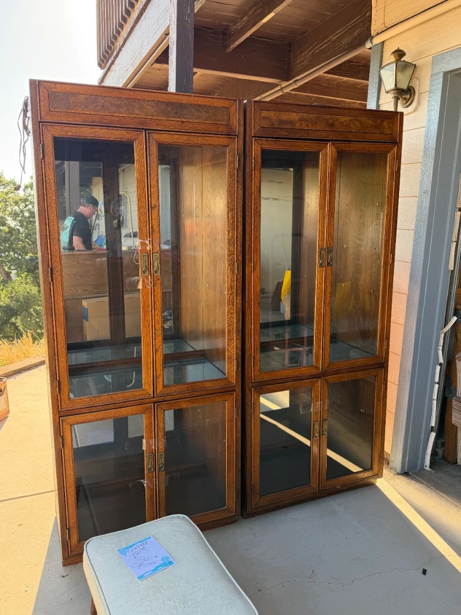 Pair of china cabinets with glass shelves and internal lighting