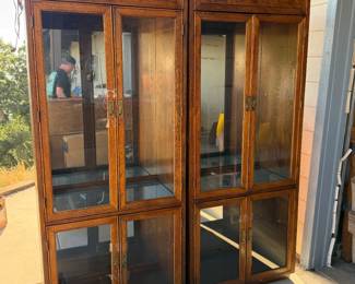 Pair of china cabinets with glass shelves and internal lighting