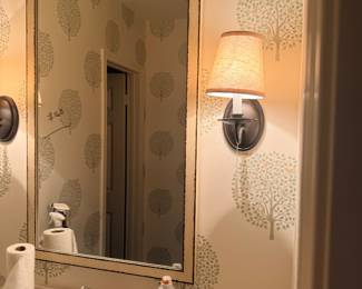 Wall sconces and mirror. Along with cabinets throughout bathrooms 