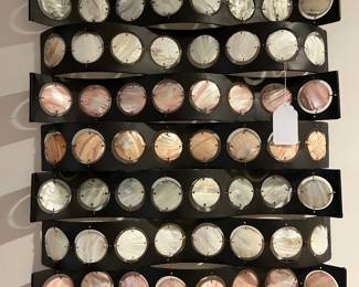 Very interesting wall art of metal and shell-like discs...very pretty, can be hung vertically or horizontally.