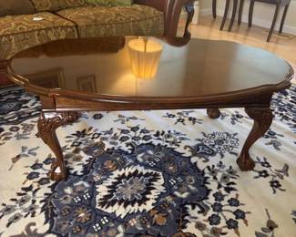 Wood Oval Claw Foot Coffee Table with Intricate Carved Details
