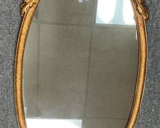 large oval gold framed mirror