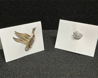 silver-colored goose brooch 