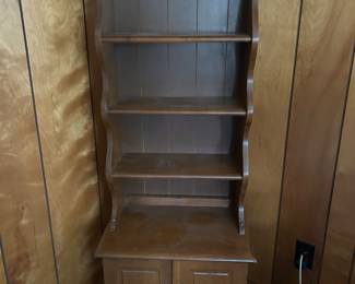 Vintage 1950’s cabinet with shelves. Shelves have grooves for standing displays. 