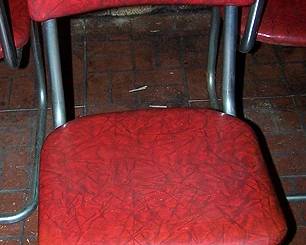 1 of 4 matching chrome and red vinyl 1950's chairs