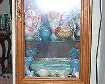 Oak display cabinet, pottery including Roseville, McCoy flower vases, Hull, Van Briggle, etc...