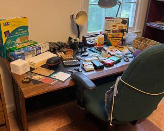Multiple desks and lots of office supplies
