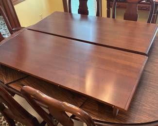 R60 - $600. Knob Creek Dining Table with 2 leaves, 6 chairs & table pad protectors. Excellent condition! Table without leaves is 66" long x 44" wide x 29" tall. 2 - 18" leaves. 2 Captains Chairs. 4 Regular Chairs. All sturdy and solid.