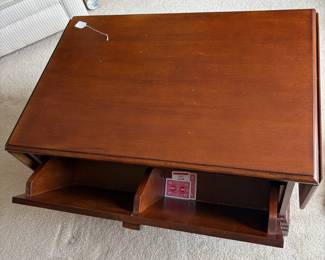 R4 - $50. Drop Leaf Coffee Table. Measures 35" wide x 24" deep x 18" tall. Very good condition! The front is doors (not drawers) the back pulls out for magazine storage.