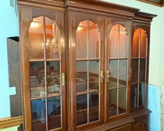 R59 - $250. Kling Lighted China Cabinet. Excellent Condition. Measures 62" wide x 18" deep x 78" tall. Moves in 2 pieces (Base is 30.5")