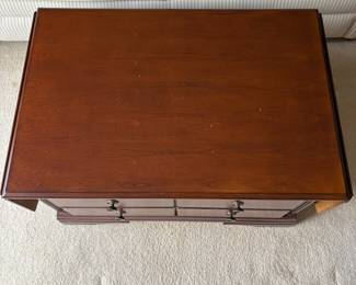 R4 - $50. Drop Leaf Coffee Table. Measures 35" wide x 24" deep x 18" tall. Very good condition! The front is doors (not drawers) the back pulls out for magazine storage.