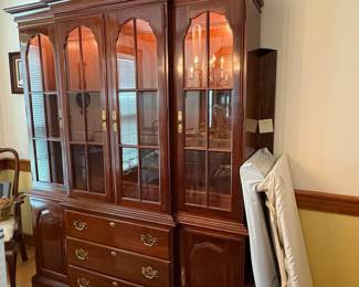 R59 - $250. Kling Lighted China Cabinet. Excellent Condition. Measures 62" wide x 18" deep x 78" tall. Moves in 2 pieces (Base is 30.5")