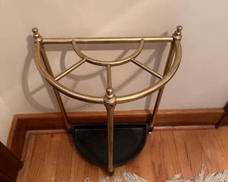 R80 - $60. Brass & Cast Iron Demi-Lune Umbrella Stand. Measures 15" x 9" x 23" tall.