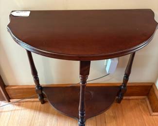 R50 - $40. Demilune Side Table. Measures 23" wide x 11.5" deep x 24.25" tall.
