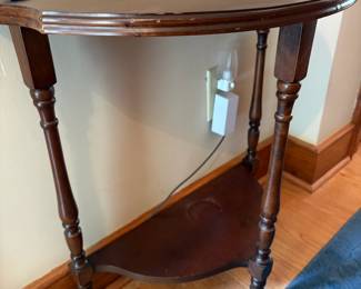 R50 - $40. Demilune Side Table. Measures 23" wide x 11.5" deep x 24.25" tall.