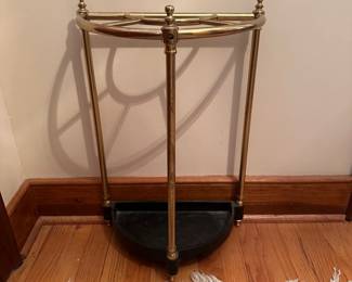 R80 - $60. Brass & Cast Iron Demi-Lune Umbrella Stand. Measures 15" x 9" x 23" tall.