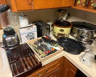 Vintage Cutco knives in bakelit holders, lifetime warranty will make them like new! Crock pots, Digital scale, toaster, Wolfgang puck cookware, Silverware drawer contents, small oval roaster