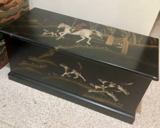 Vintage black toleware blanket chest features a hand-painted equestrian fox hunt.
