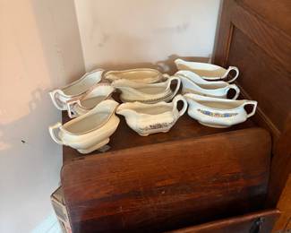 A collection of vintage antique China gravy boats and vintage school desk 