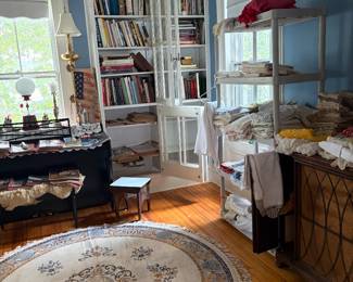 Stereo cabinet and a very large assortment of beautiful press linens and handmade doilies