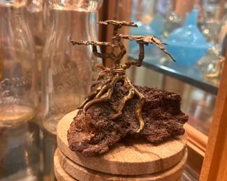Vintage brass bonsai tree on wood