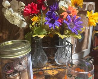 Wooden spools; faux flowers in small vases; vintage juice glasses